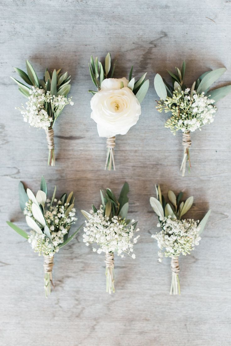 Bride kissing her groom while holding a white bridal bouquet by Lammar Flower Studio Bali